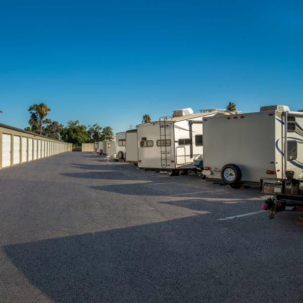 RVs and a boat parked safely at StorQuest Self Storage in Acampo, California