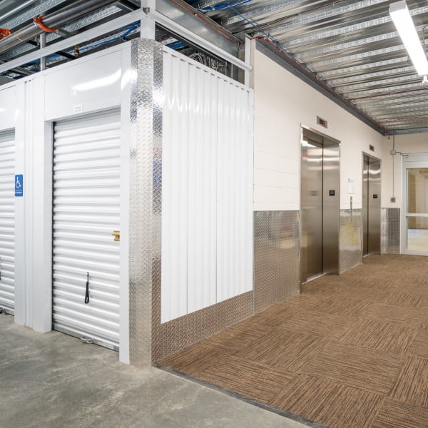 Indoor storage units with white doors at StorQuest Self Storage in West Babylon, New York