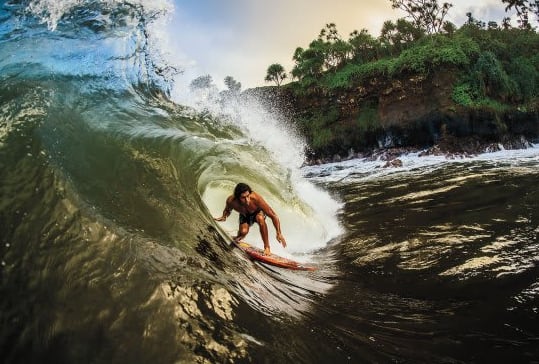 Dr. Cliff Kapono surfing a big wave