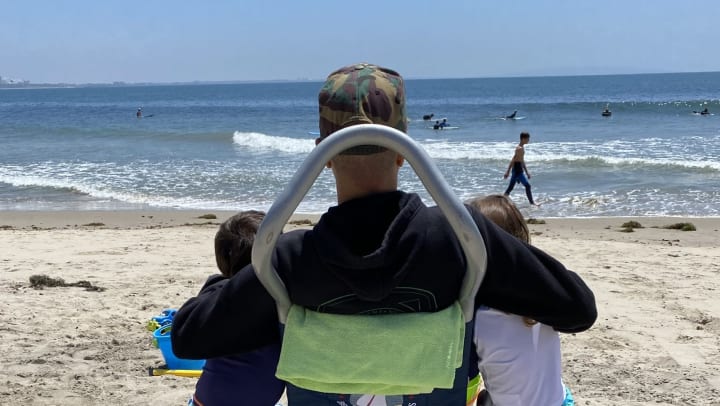 Jesse Billauer on the beach with his kids