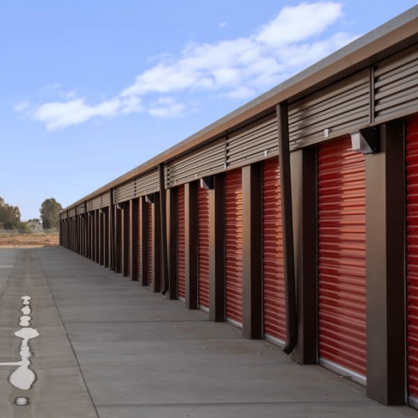 Outdoor storage units with red doors at StorQuest Self Storage in Fresno, California