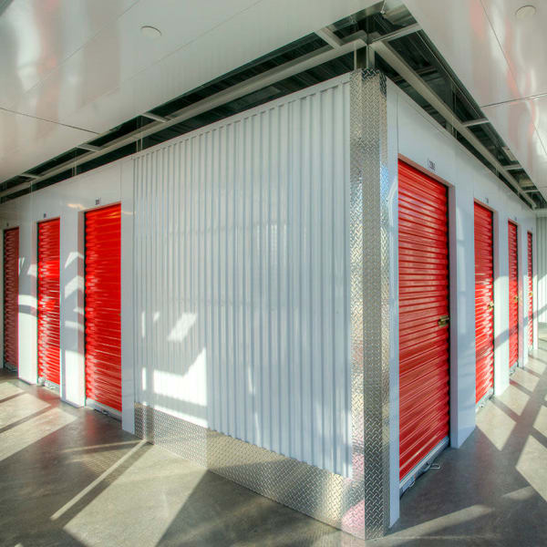 Indoor storage units with bright doors at StorQuest Express Self Service Storage in Deltona, Florida