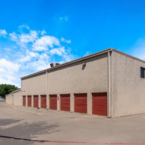 Outdoor storage units with bright doors at StorQuest Self Storage in Dallas, Texas