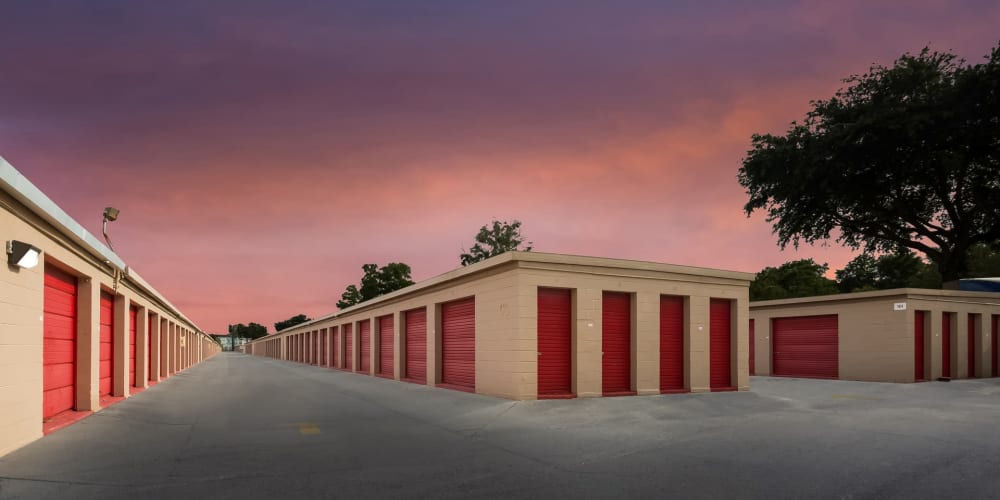 Drive-up access storage units with red doors at StorQuest Self Storage in Tampa, Florida